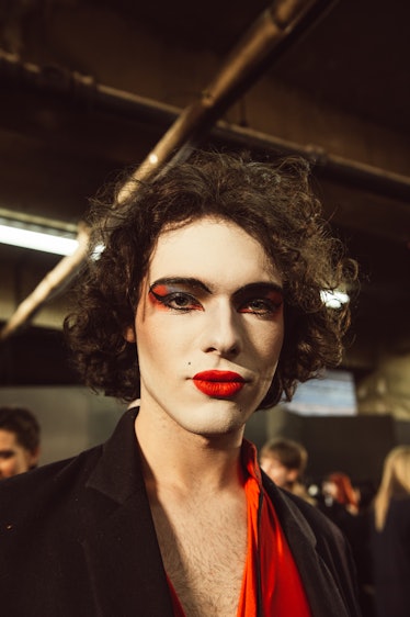 A male model with white makeup on his face at Charles Jeffrey’s MAN Fall 2017 presentation