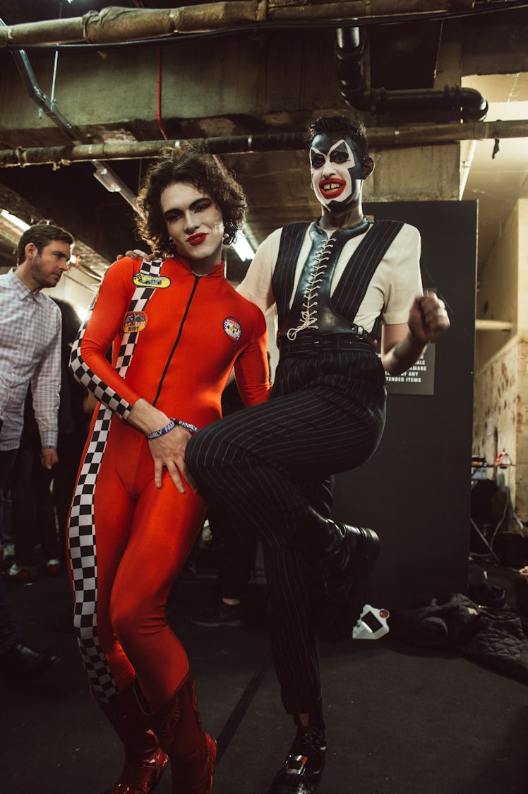 Two models in red and black outfits posing for a photo at Charles Jeffrey’s MAN Fall 2017 presentati...