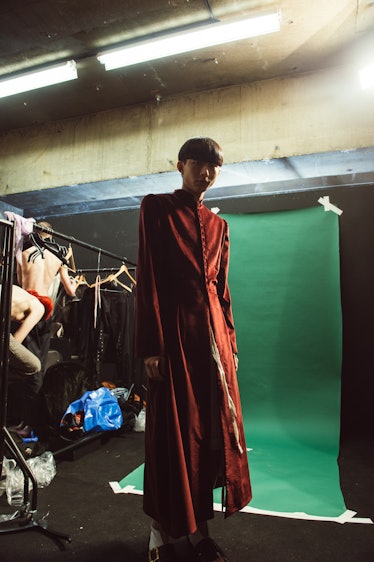 A model wearing a red gown at Charles Jeffrey’s MAN Fall 2017 presentation