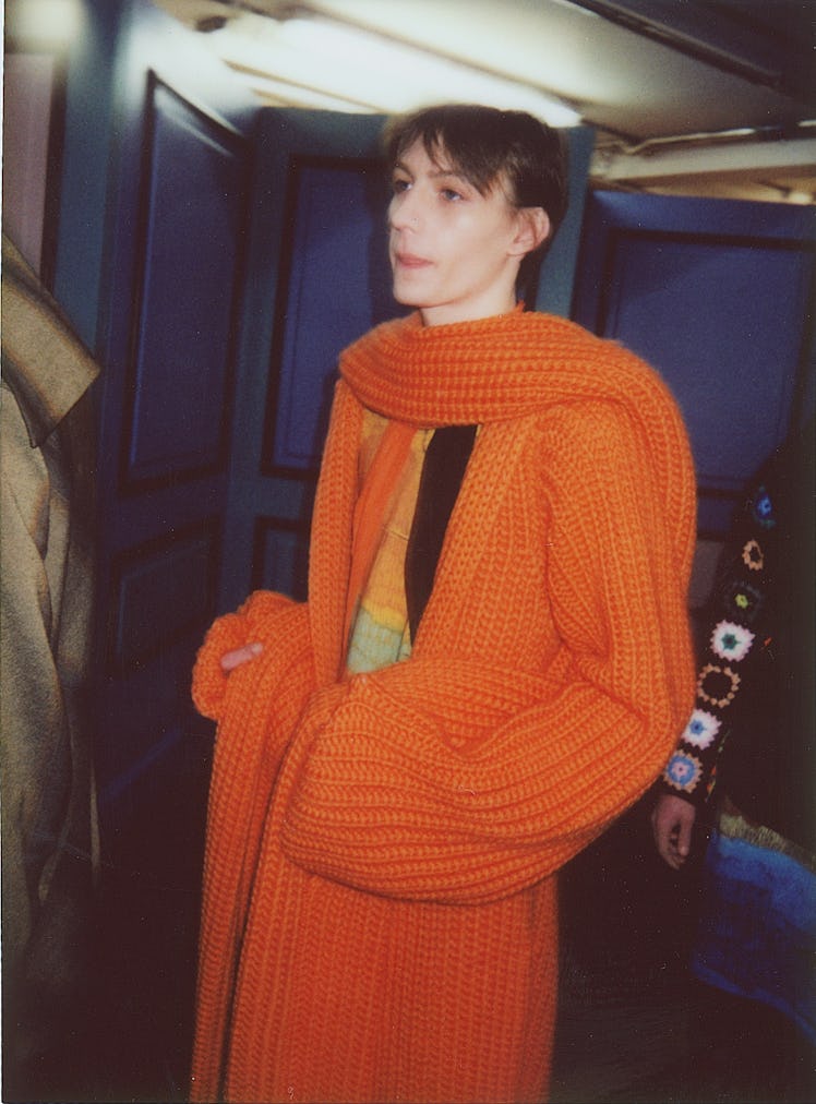 A model wearing an orange knit coat from J.W. Anderson’s Fall/Winter 2017 Collection.