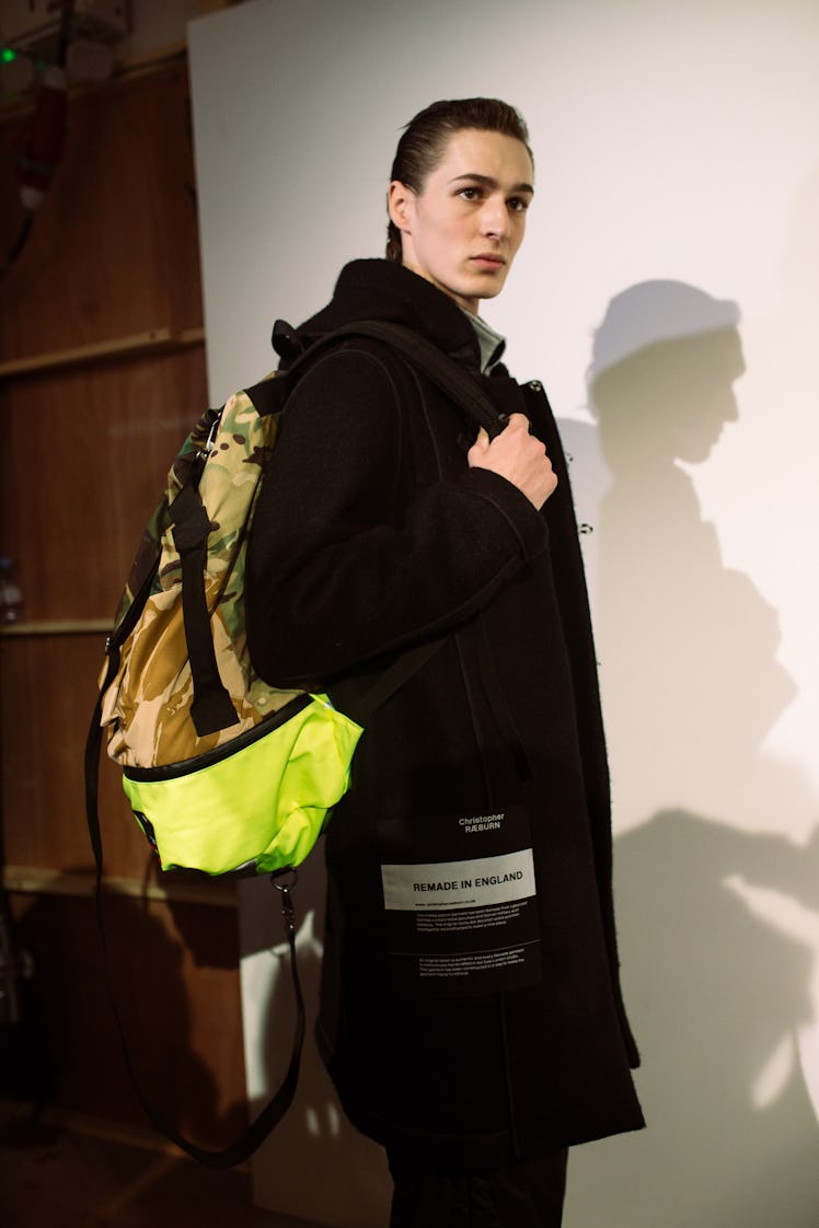 A model carrying a backpack from Christopher Ræburn’s Fall/Winter 2017 Collection.