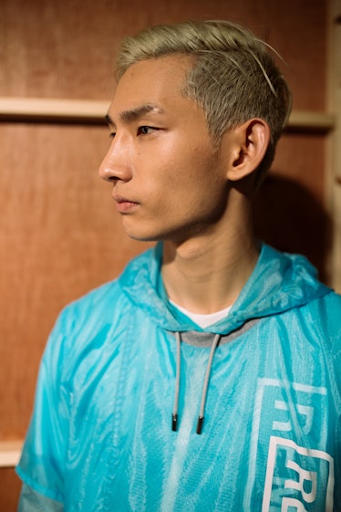 A model wearing a blue jacket by London Men’s Designer Christopher Ræburn
