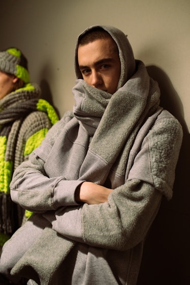 A model wearing a grey sustainable hoodie from Christopher Ræburn’s Fall/Winter 2017 Collection.