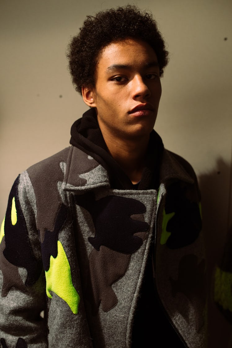 A model wearing a camouflage jacket from Christopher Ræburn’s Fall/Winter 2017 Collection.