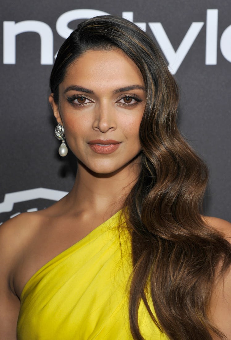 Deepika Padukone wearing a yellow dress and David Webb Jewels at InStyle Golden Globes Party.