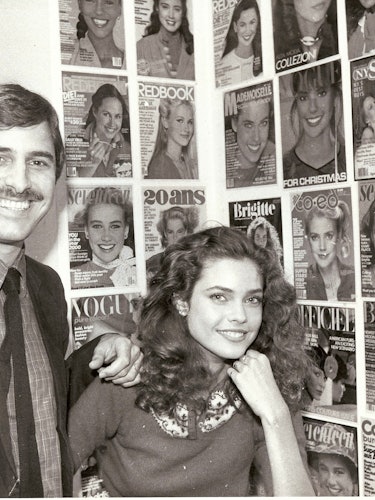 John Casablancas and a model in front of a wall of magazine covers