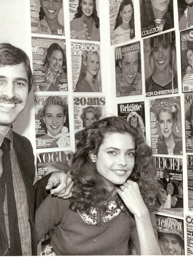 John Casablancas and a model in front of a wall of magazine covers
