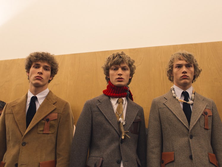 Three models standing in a brown, camel and beige jacket at the Fall 2017 Prada Fashion Show
