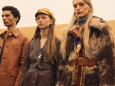 Three models posing backstage at the Fall 2017 Prada Fashion Show