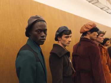 A group of six models with a neutral facial expression backstage at the Fall 2017 Prada Fashion Show