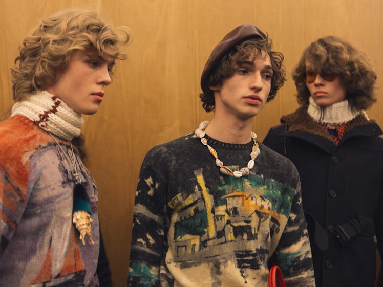 A group of three models in multi-colored tops backstage at the Fall 2017 Prada Fashion Show