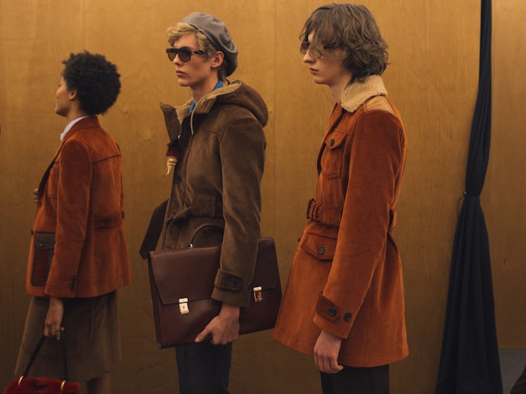 Three models in brown and camel outfits backstage at the Fall 2017 Prada Fashion Show