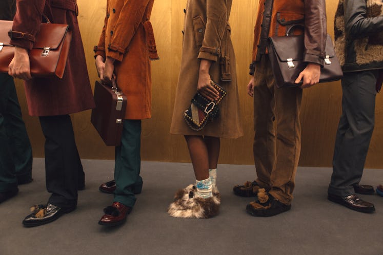 A row of 5 models wearing brown and camel clothes at the Fall 2017 Prada Fashion Show