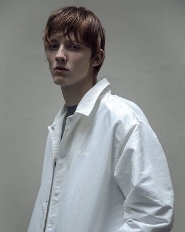 Male model, Karlis Leiboms, posing in a white shirt.
