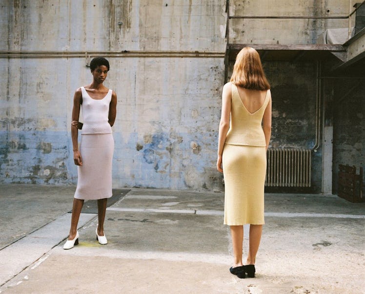 Two models facing each other, wearing vanilla and lilac tops and skirts from the Hesperios Spring Su...