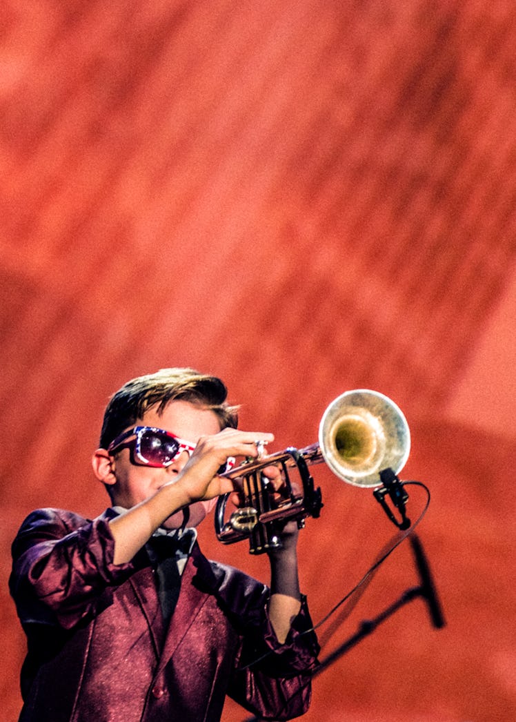 A boy playing trumpet on stage during Donald J. Trump’s Inauguration Ball