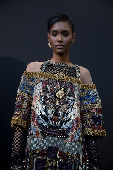 A model posing in sequined Balmain Fall 2017 off-shoulder dress.