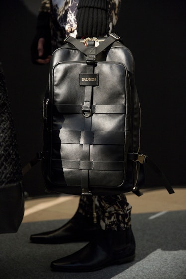 A model holding Balmain Men’s Fall 2017 black leather backpack.