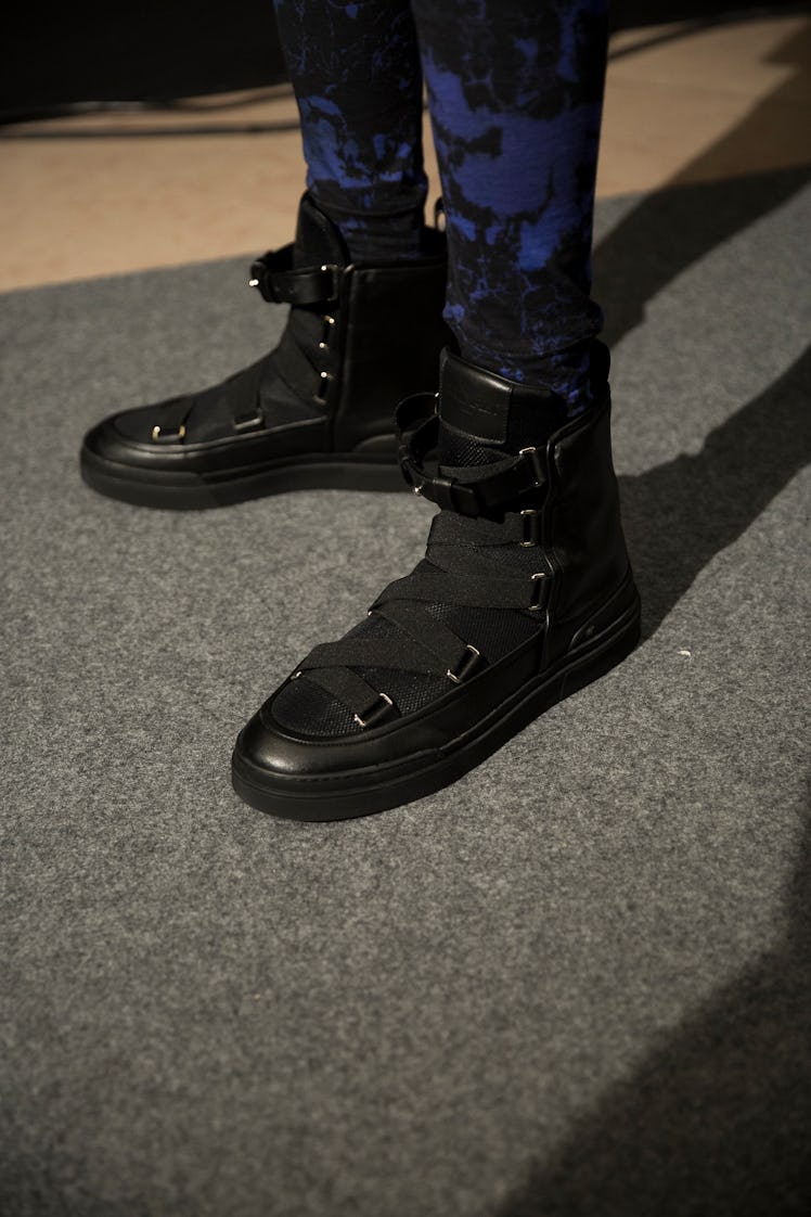 A model in Balmain Men’s Fall 2017 black boots.