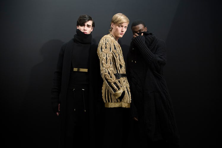 Models posing backstage at Balmain Men’s Fall 2017.