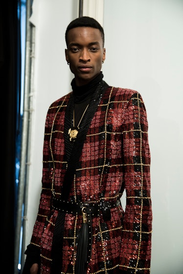 A model posing in Balmain Men’s Fall 2017 sequined blazer.