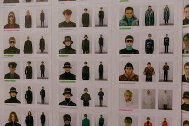 A wall full of Polaroids of the models who participated in the Dior Homme Fall 2017 show 