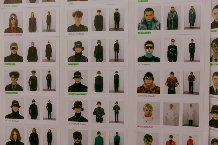 A wall full of Polaroids of the models who participated in the Dior Homme Fall 2017 show 