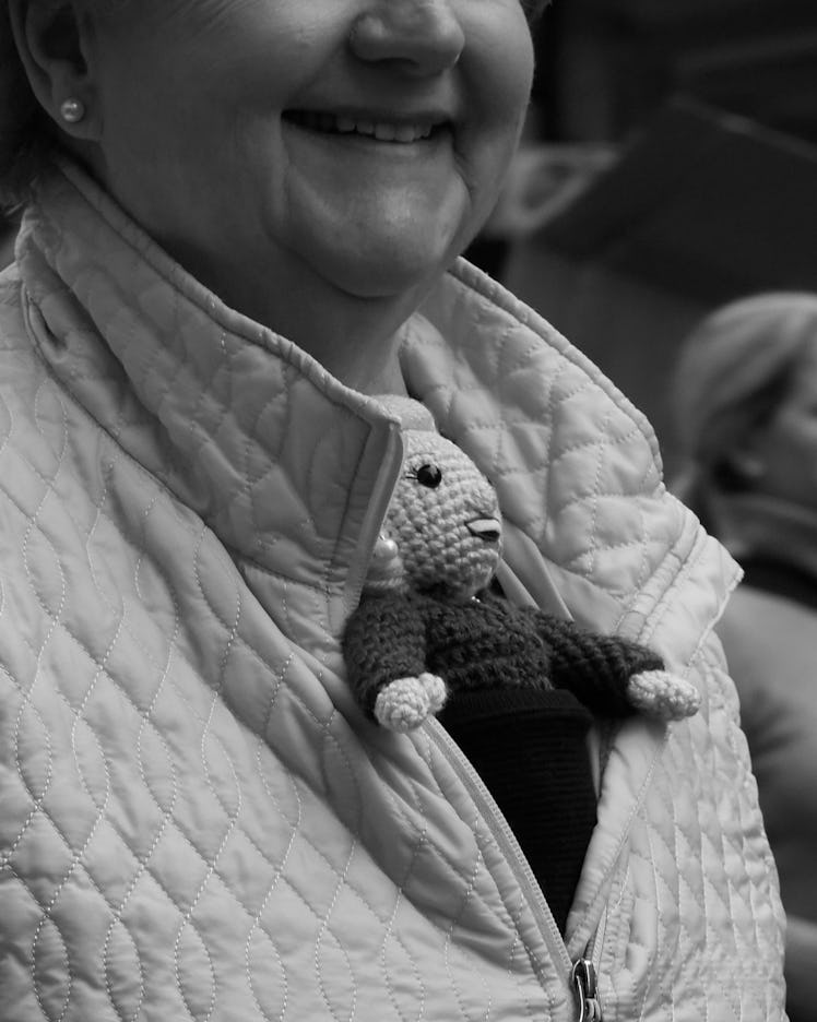 A close-up of a woman in a jacket with a small knit doll on her chest at the Women’s March in Washin...