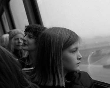 A young girl looking through a window in a bus on her way to the Women’s March in Washington D.C.