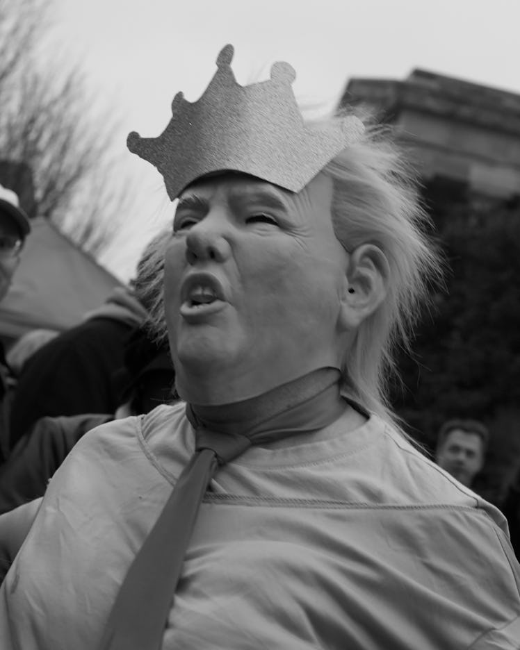 A person wearing a Donald Trump mask and a crown at the Women’s March in Washington D.C.
