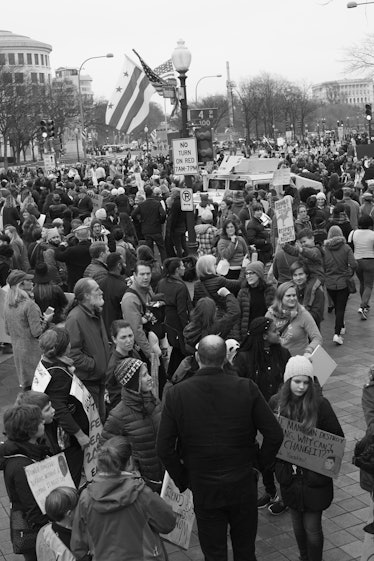 A semi-aerial shot of a crowd walking with protest posters at the Women’s March in Washington D.C.