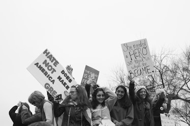 A group of young women gathered together and holding protest posters at the Women's March in Washing...