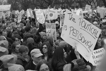 A large crowd gathered together and holding protest posters at the Women's March in Washington D.C.