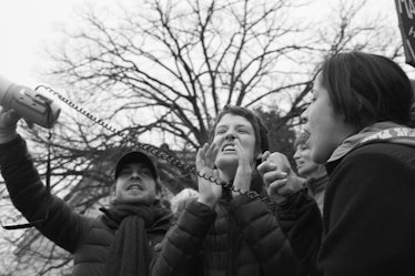 A woman yelling and two people standing on her left and her right side at the Women’s March in Washi...