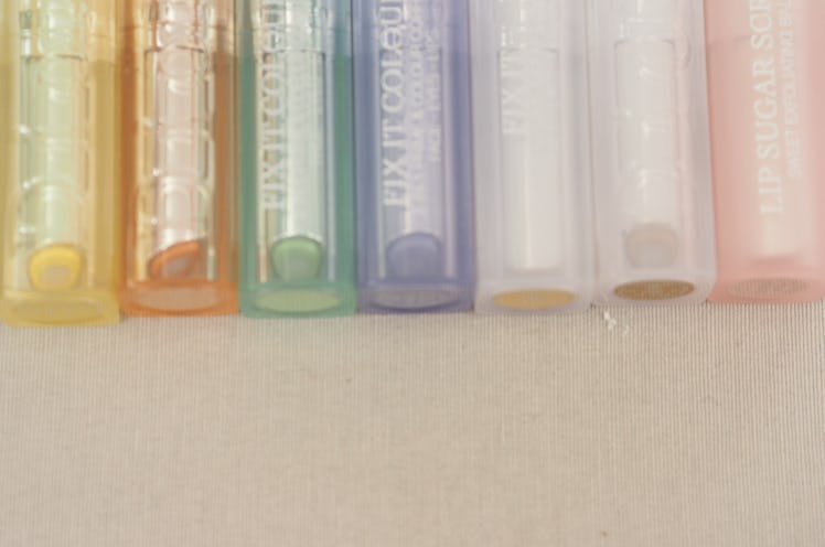 Lipsticks in pastel hues lined up on the table.