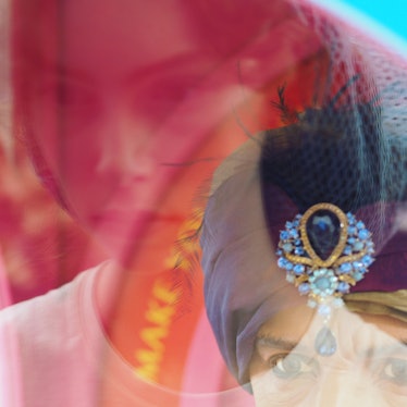 A model wearing a rhinestone-adorned turban