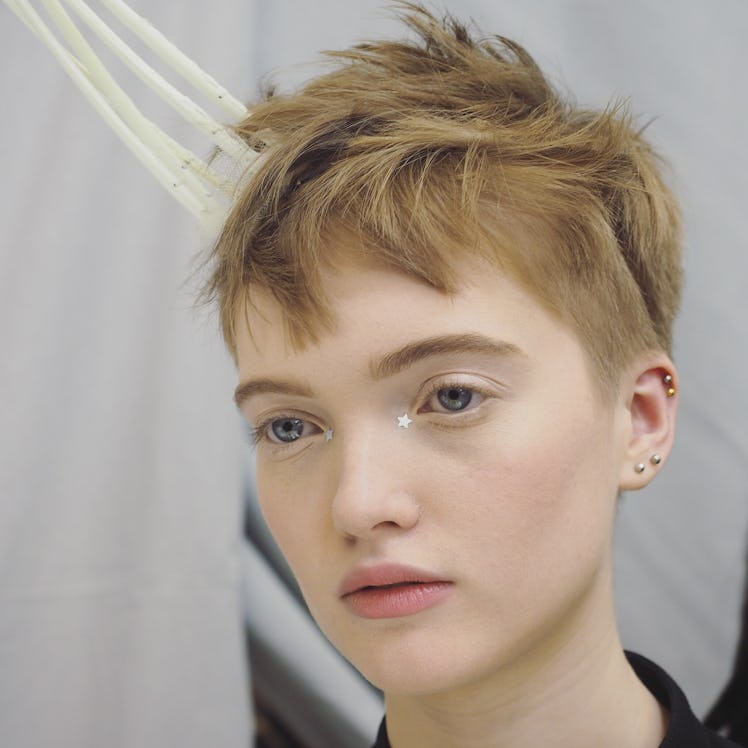 A short-haired model backstage during Christian Dior Haute Couture Spring 2017 show.