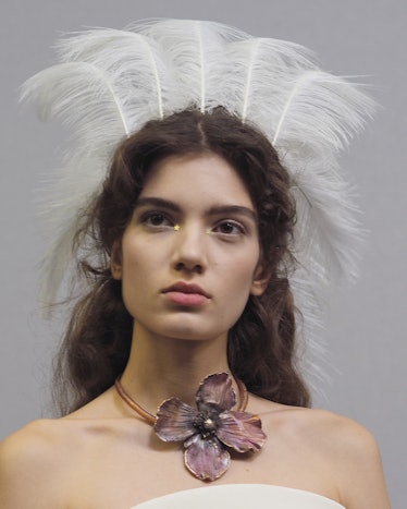 A model with white feathers crown during Christian Dior Haute Couture Spring 2017 show.