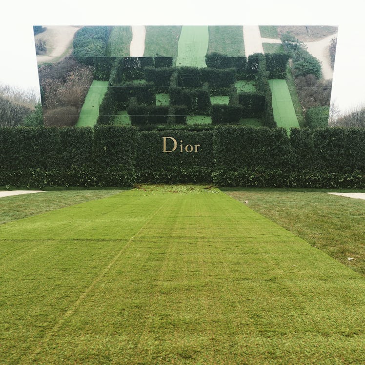 A garden with a maze with the Dior logo on its entrance.