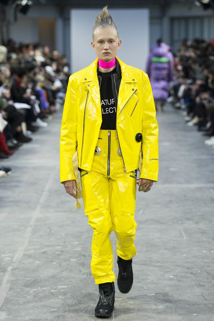 A model wearing a yellow jacket and pants with a pink choker at the Sankuanz Fall 2017 runway