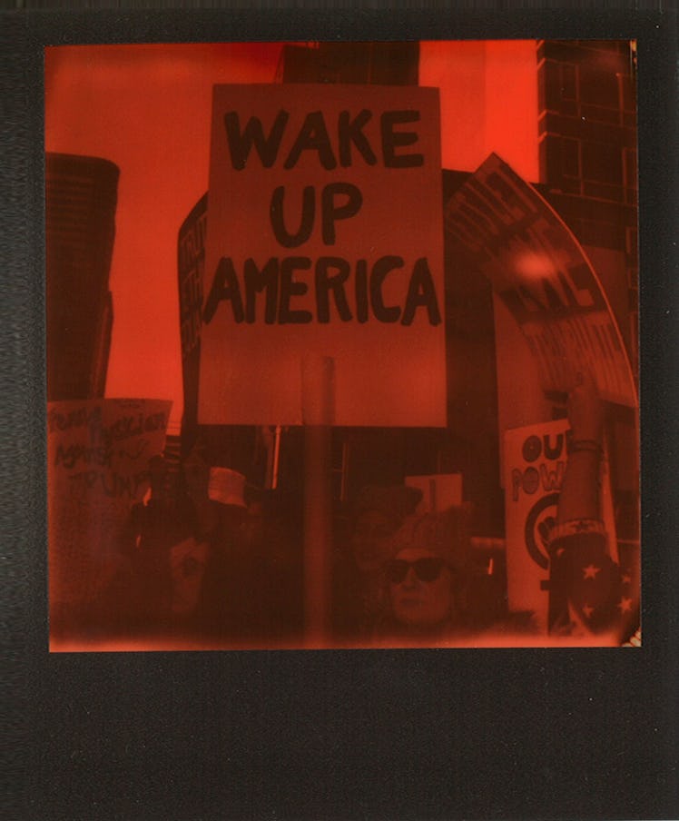 A poster with "WAKE UP AMERICA" text at the Women’s March in NYC