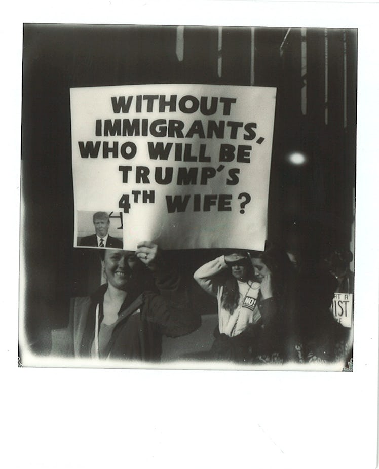 A poster with "WITHOUT IMMIGRANTS, WHO WILL BE TRUMP'S 4TH WIFE?" text at the Women’s March in NYC