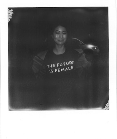 A woman wearing a black shirt with "THE FUTURE IS FEMALE" text