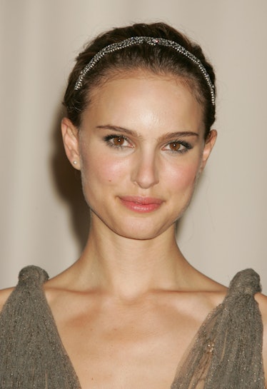 Natalie Portman in a grey dress, with an up do and a silver headband at the Oscars