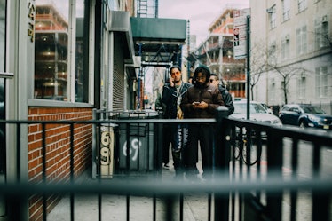 Two people approaching the Hood by Air Sample Sale Street Style location in the distance