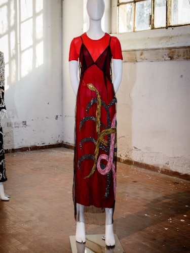 A mannequin in a red-black sating and tulle dress