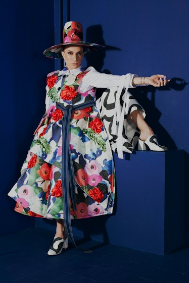 A model in a floral dress and a floral top hat from his Danial Aitouganov's collection titled The Se...