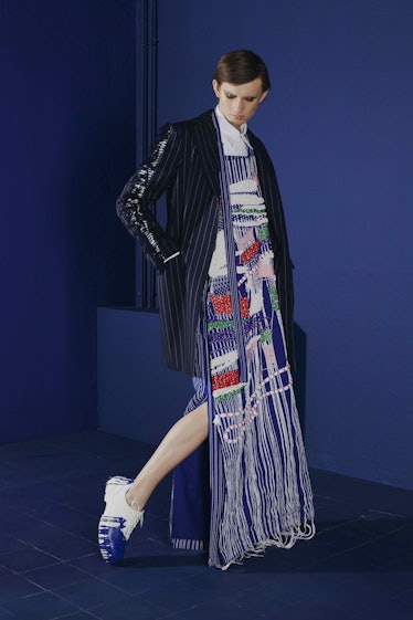 A model in a shiny striped blazer and fringe maxi-dress from her collection: “Work?!” by Gesine Förs...