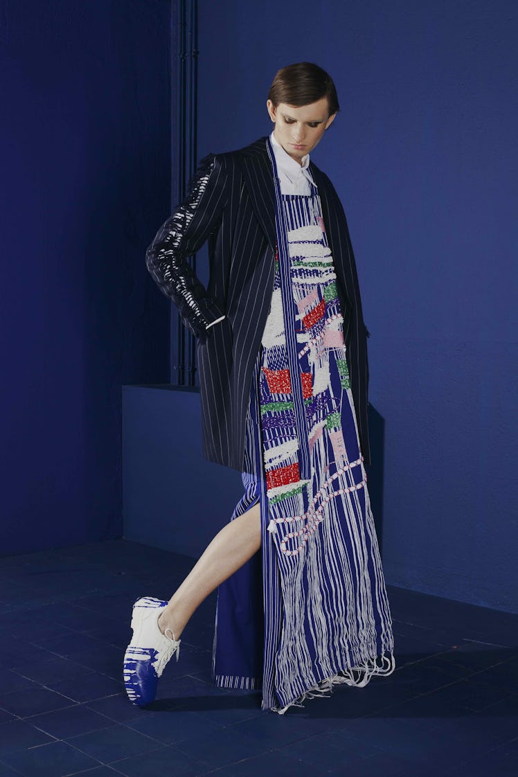A model in a shiny striped blazer and fringe maxi-dress from her collection: “Work?!” by Gesine Förs...