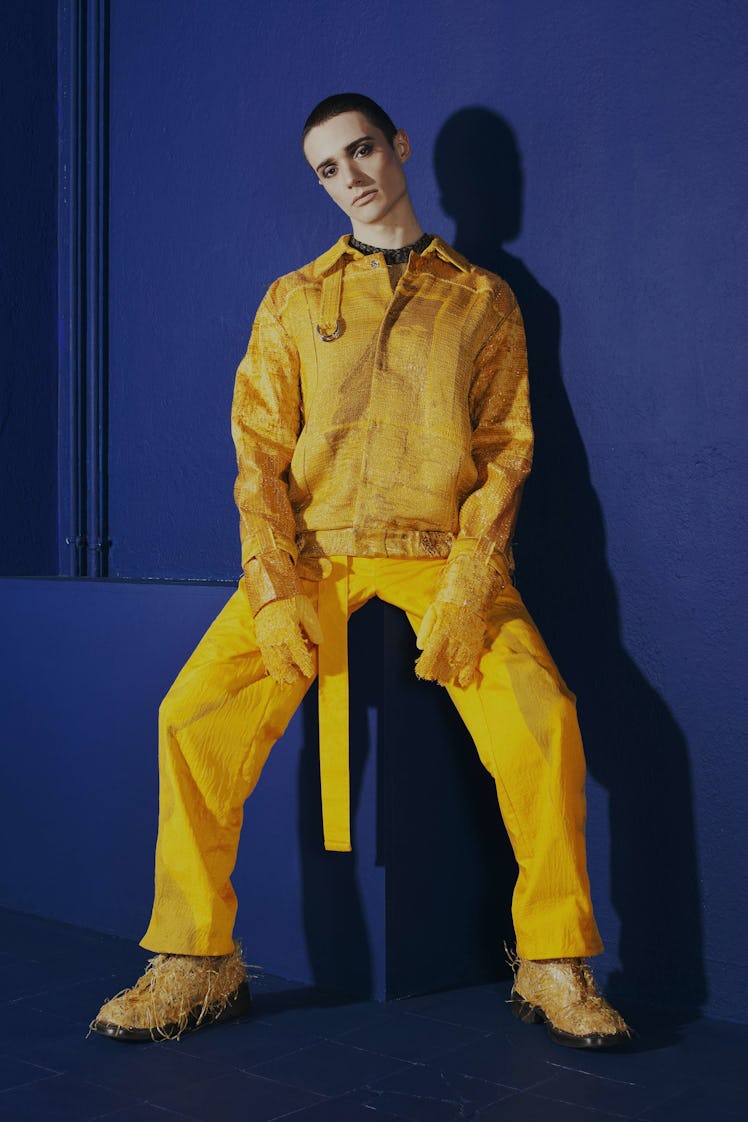 A model in a yellow leather jacket, yellow pants and matching shoes by Maria Korkeila